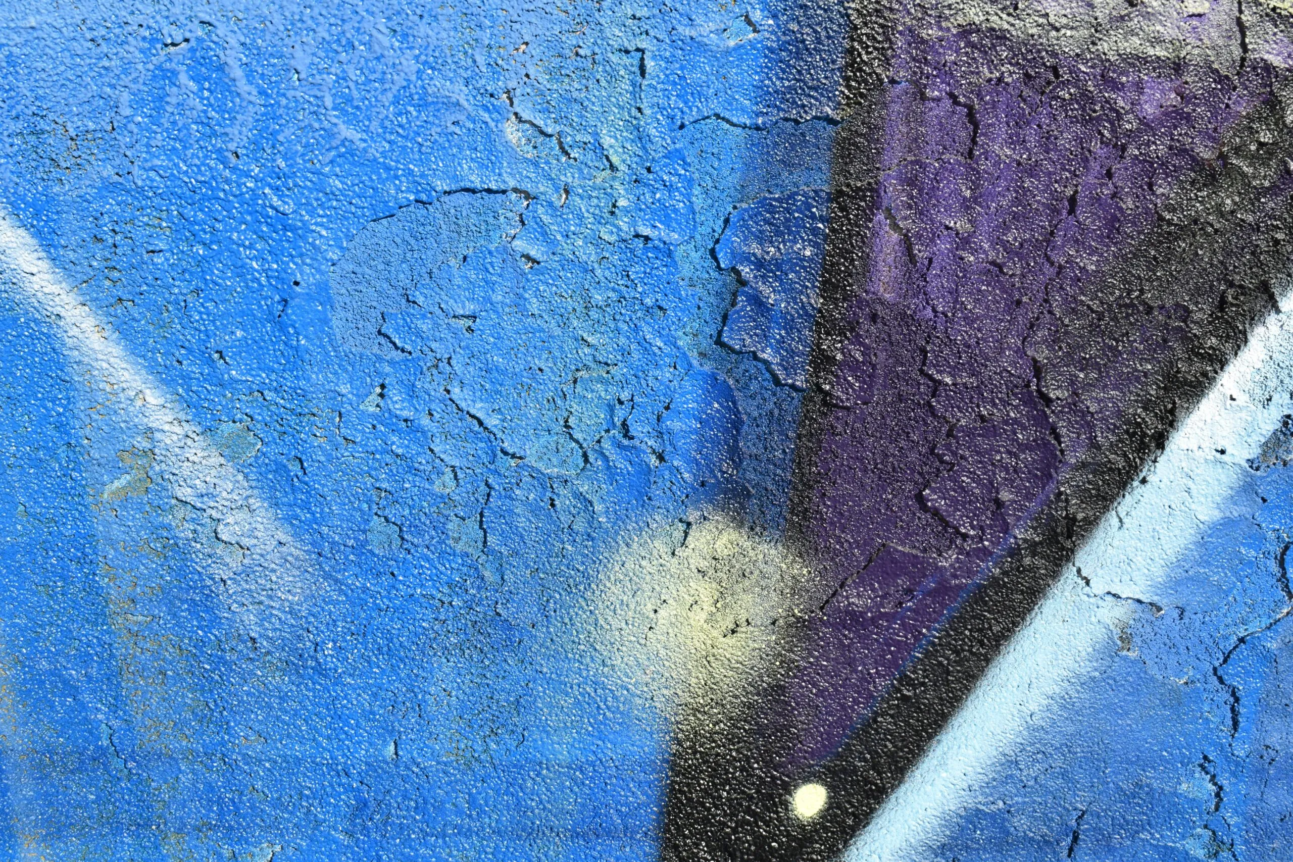 a close up of a blue and purple wall
