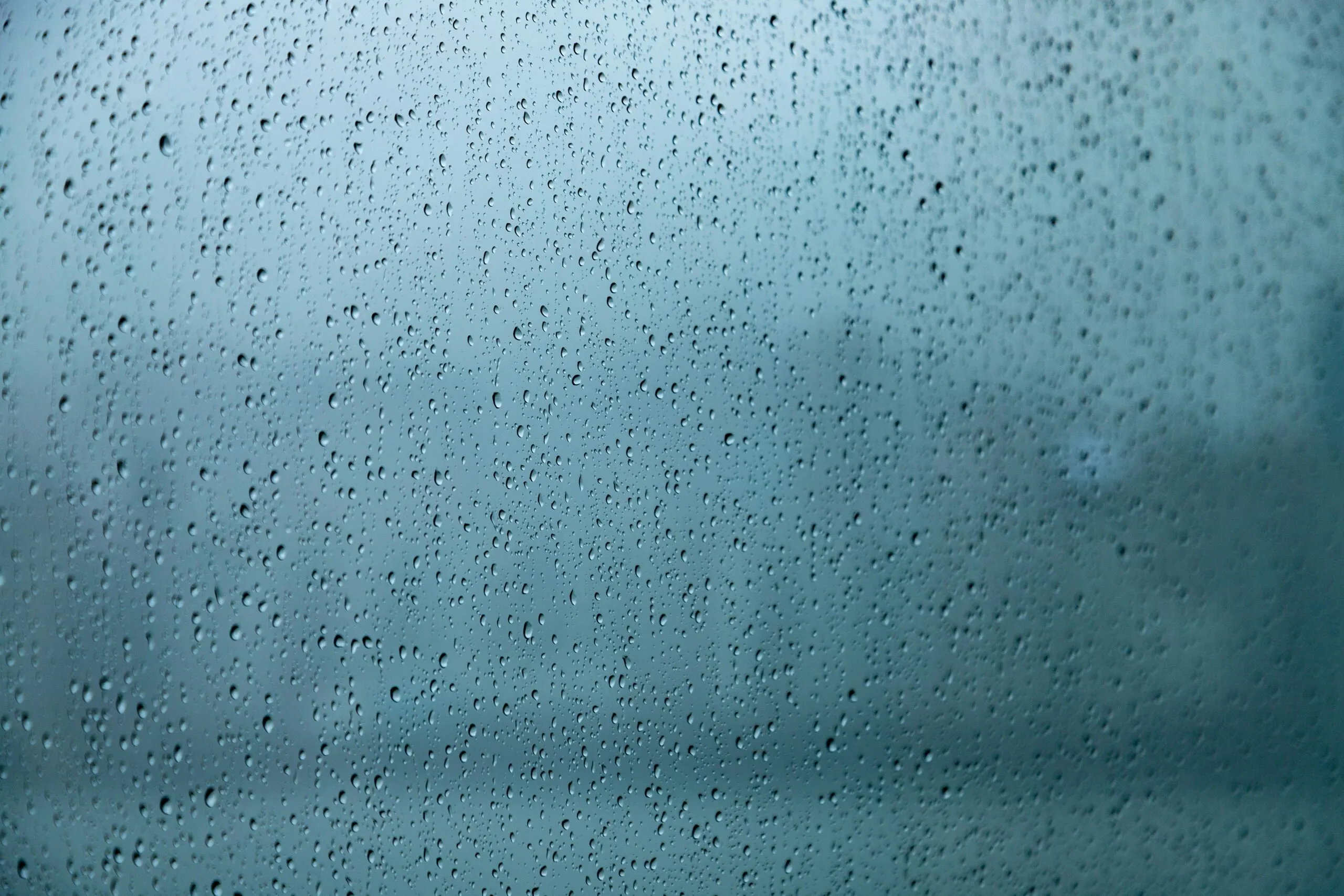 A close up of a window with rain drops