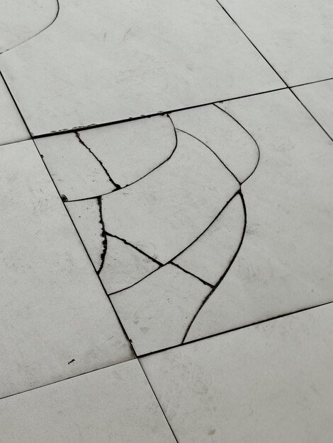 Image of a cracked and light colored floor tile