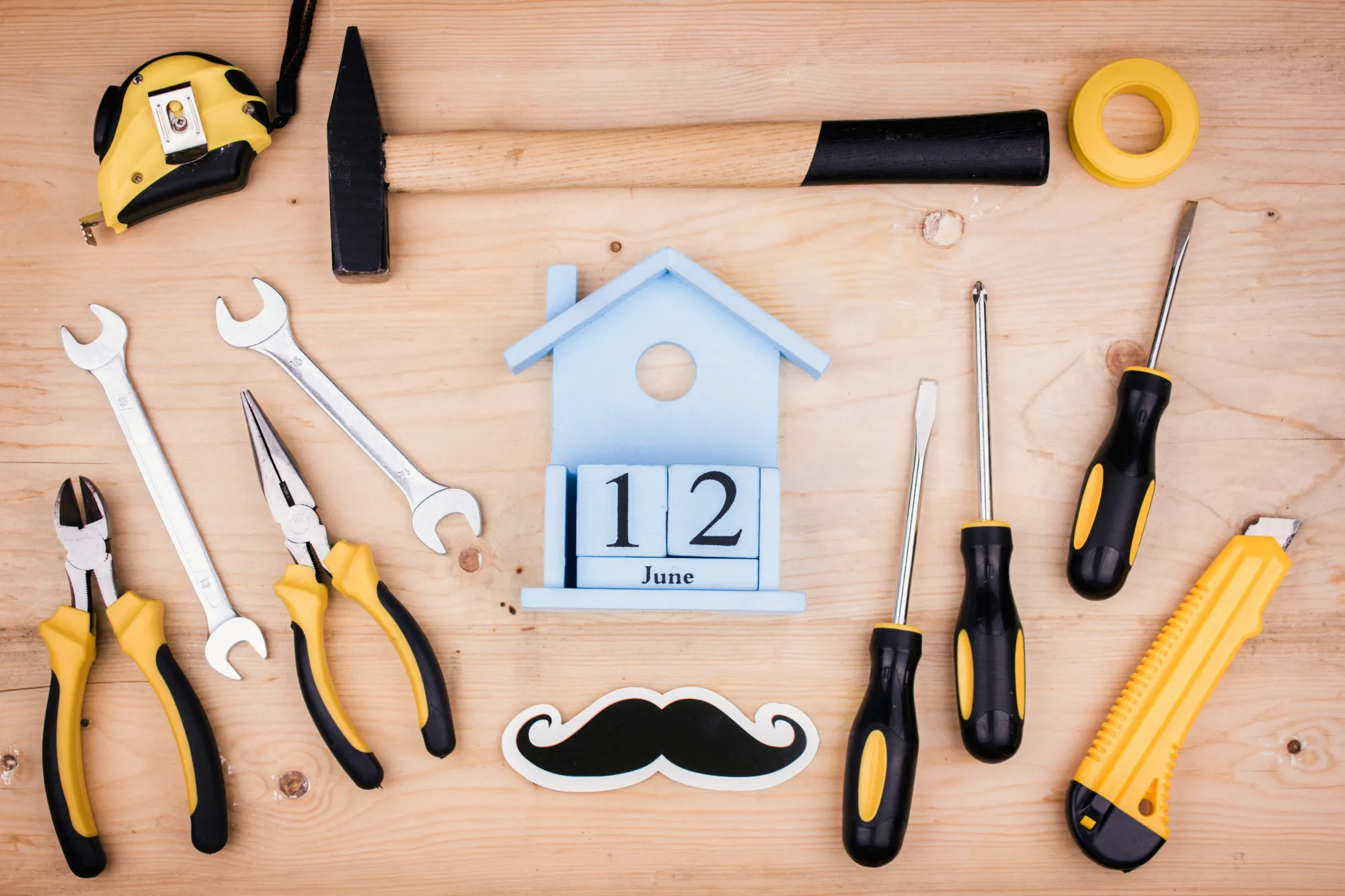 June 12 - Father's Day. Male concept. Repair tools - hammer, screwdrivers, adjustable wrenches, pliers. Sheet of white paper.