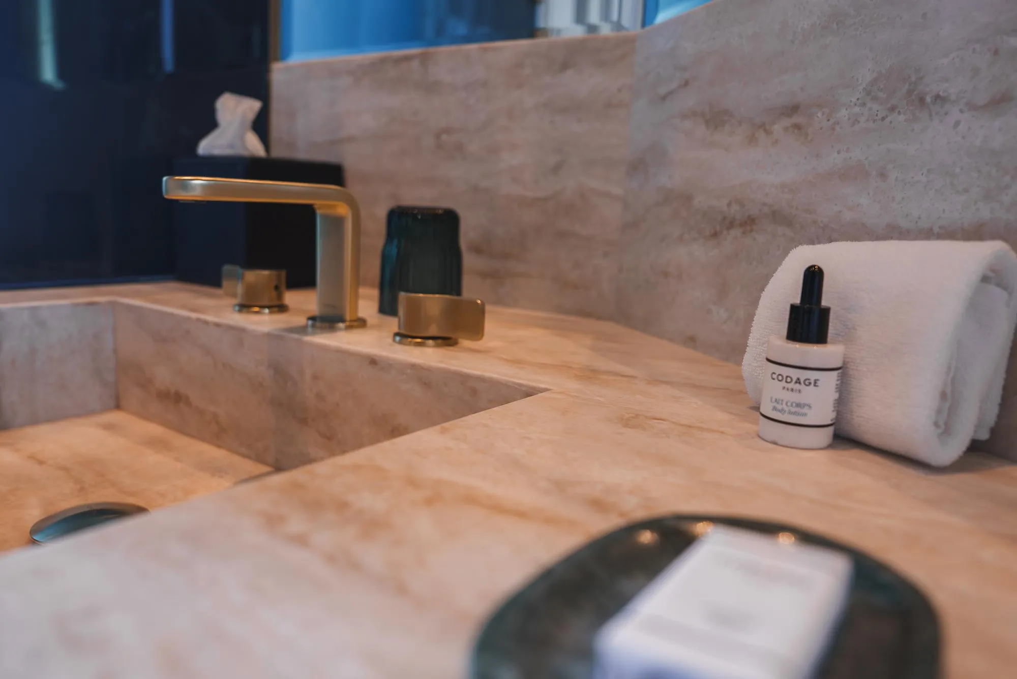 Luxurious Bathroom Sink Area with Marble Countertop and Gold Faucet