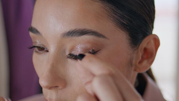 Makeup woman applying eyelashes at room closeup lady face doing perfect visage