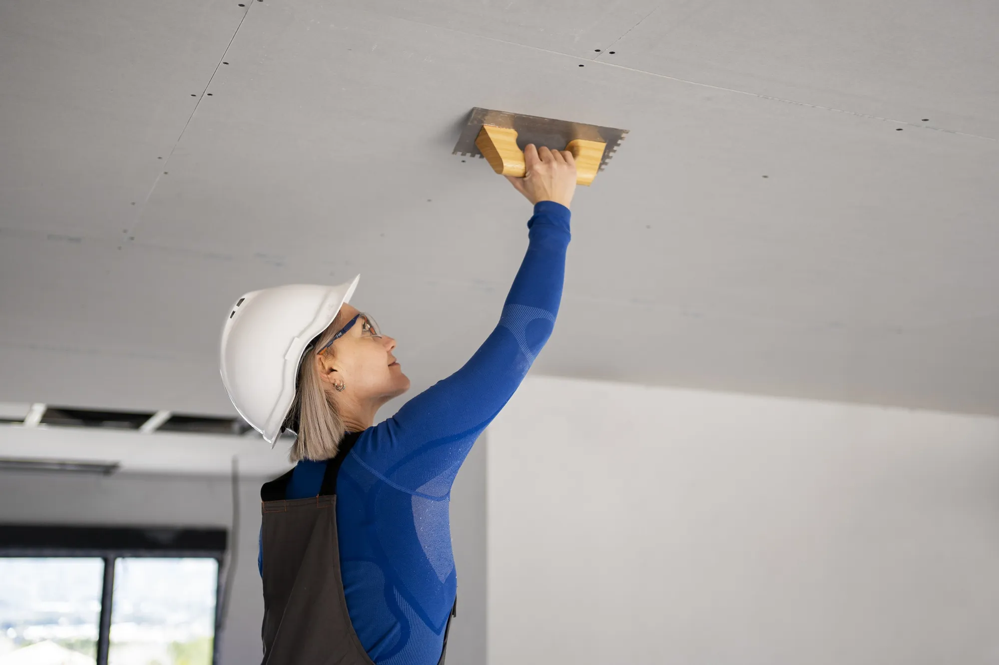 Medium shot smiley woman fixing roof
