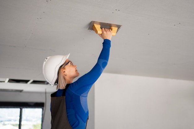 Medium shot smiley woman fixing roof