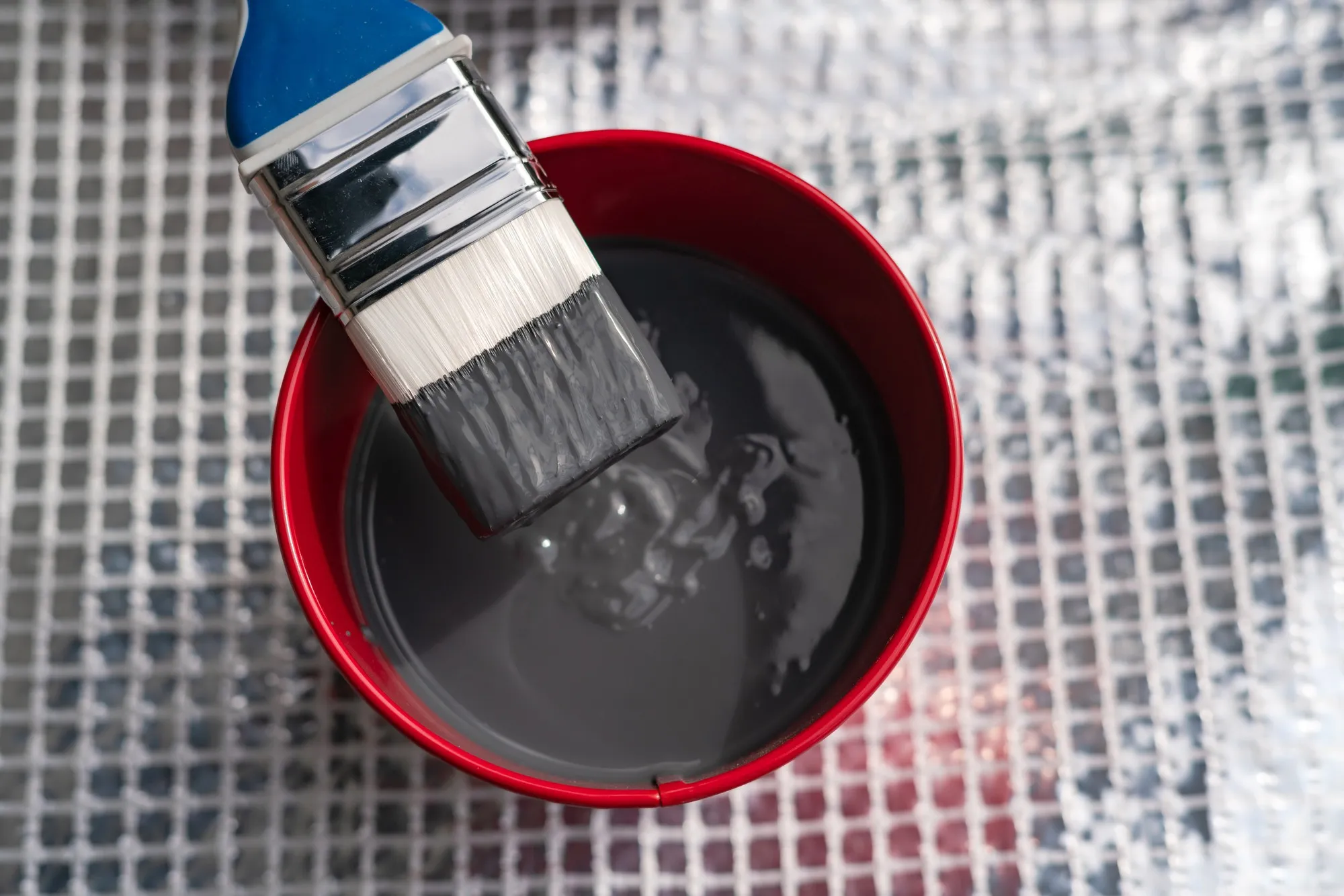 Paint brush and a bucket with paint still life.