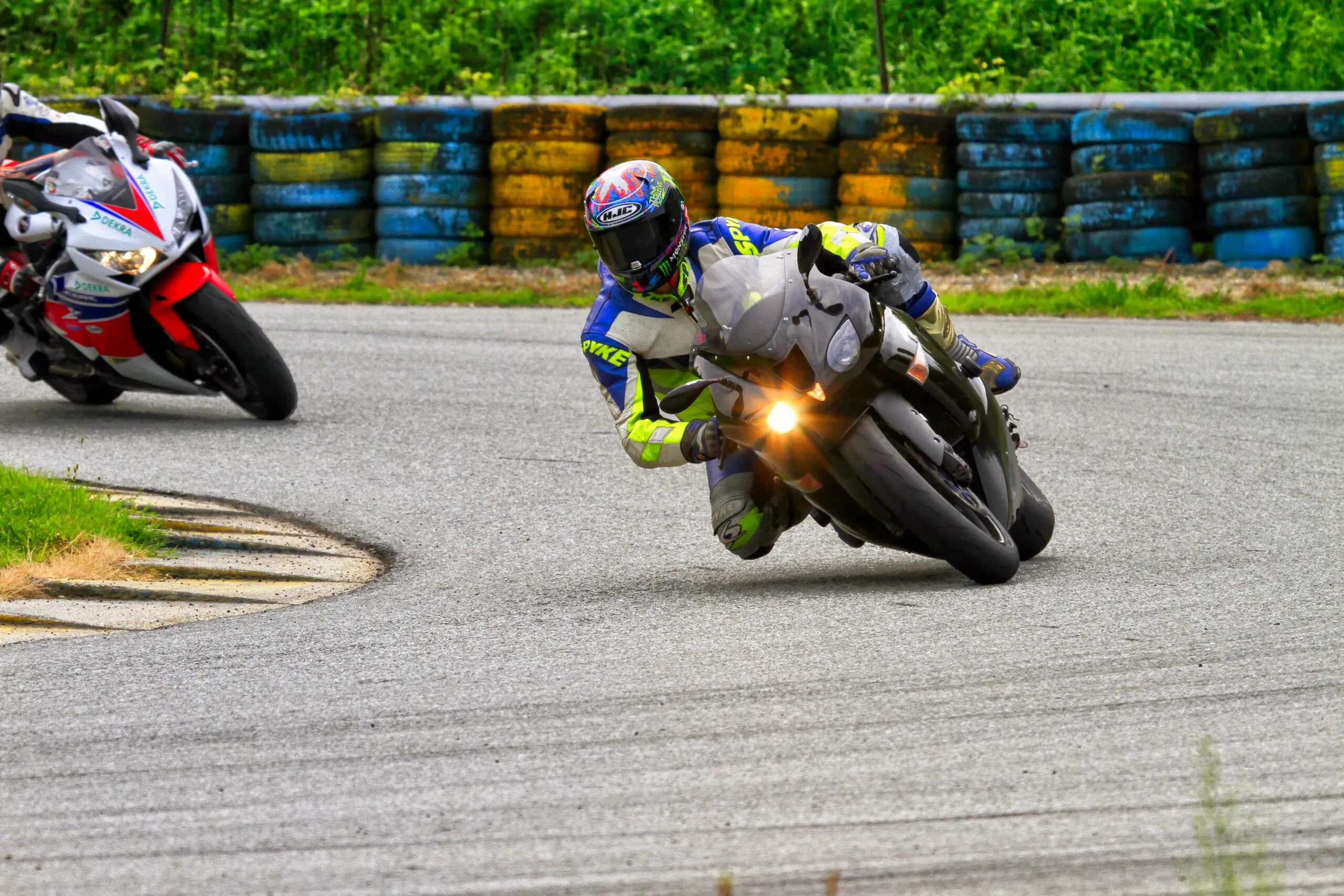 Motorcyclist leaning into a sharp turn during a thrilling motorsport race on track.