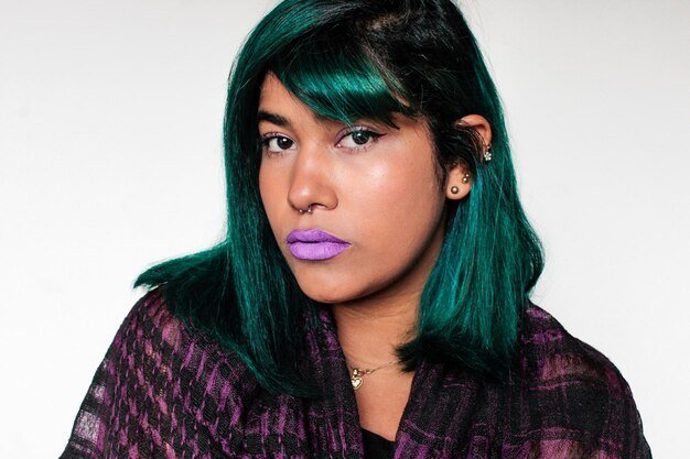 Portrait of beautiful young woman against white background