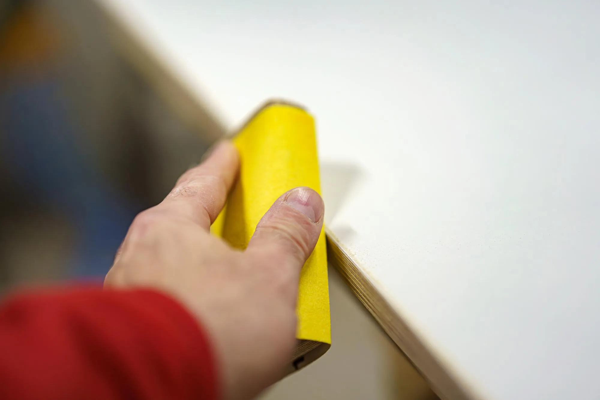 Sanding down burrs on a piece of furniture in a carpentry shop Furniture manufacturing plant