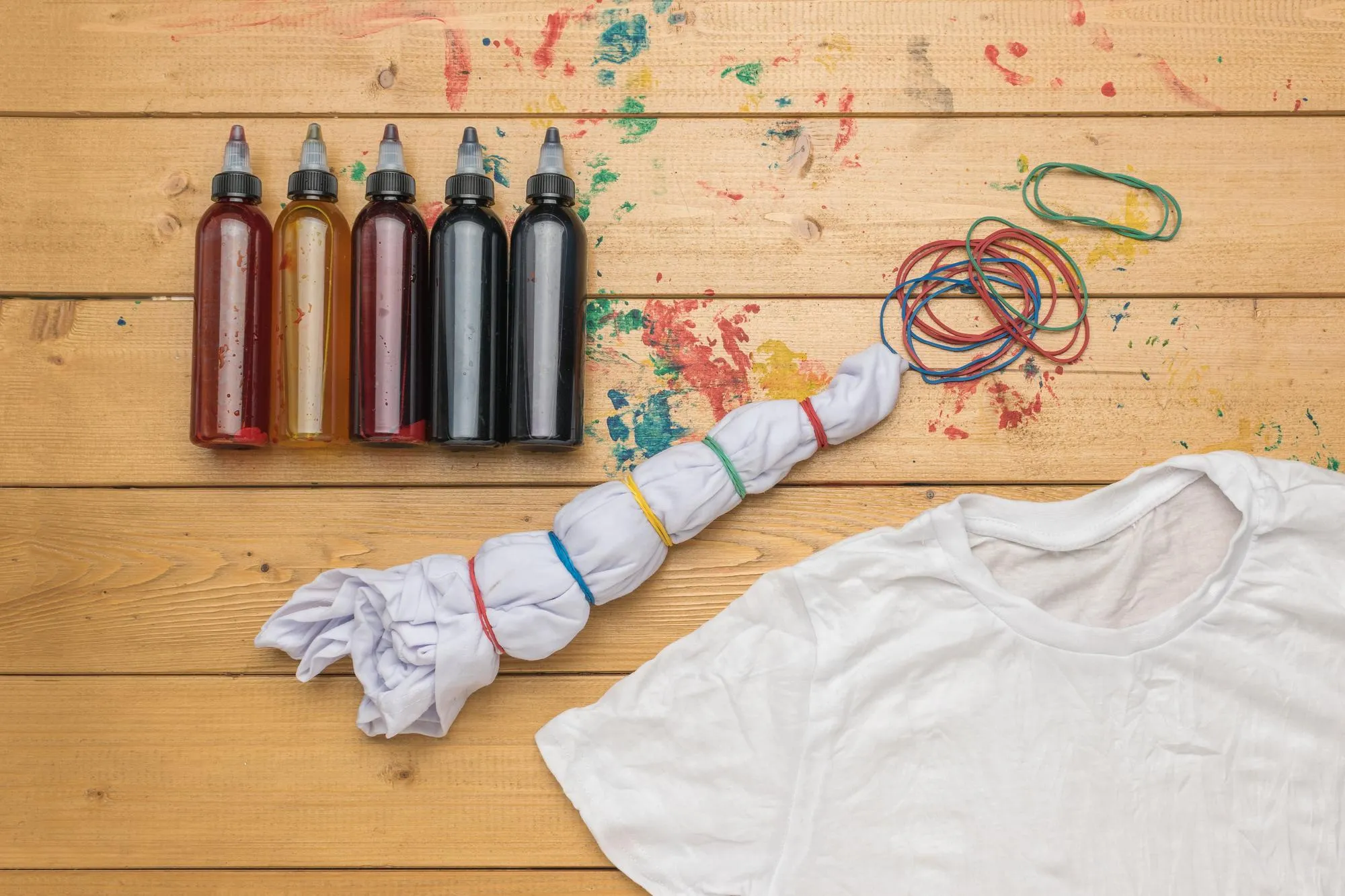 A set of paints and Tshirts prepared for coloring in tie dye style Making clothes at home