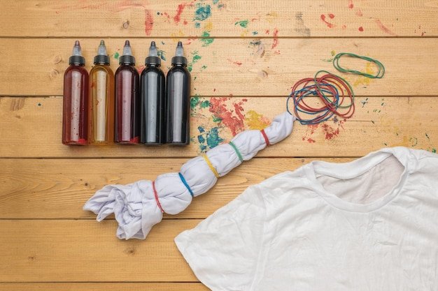 A set of paints and Tshirts prepared for coloring in tie dye style Making clothes at home
