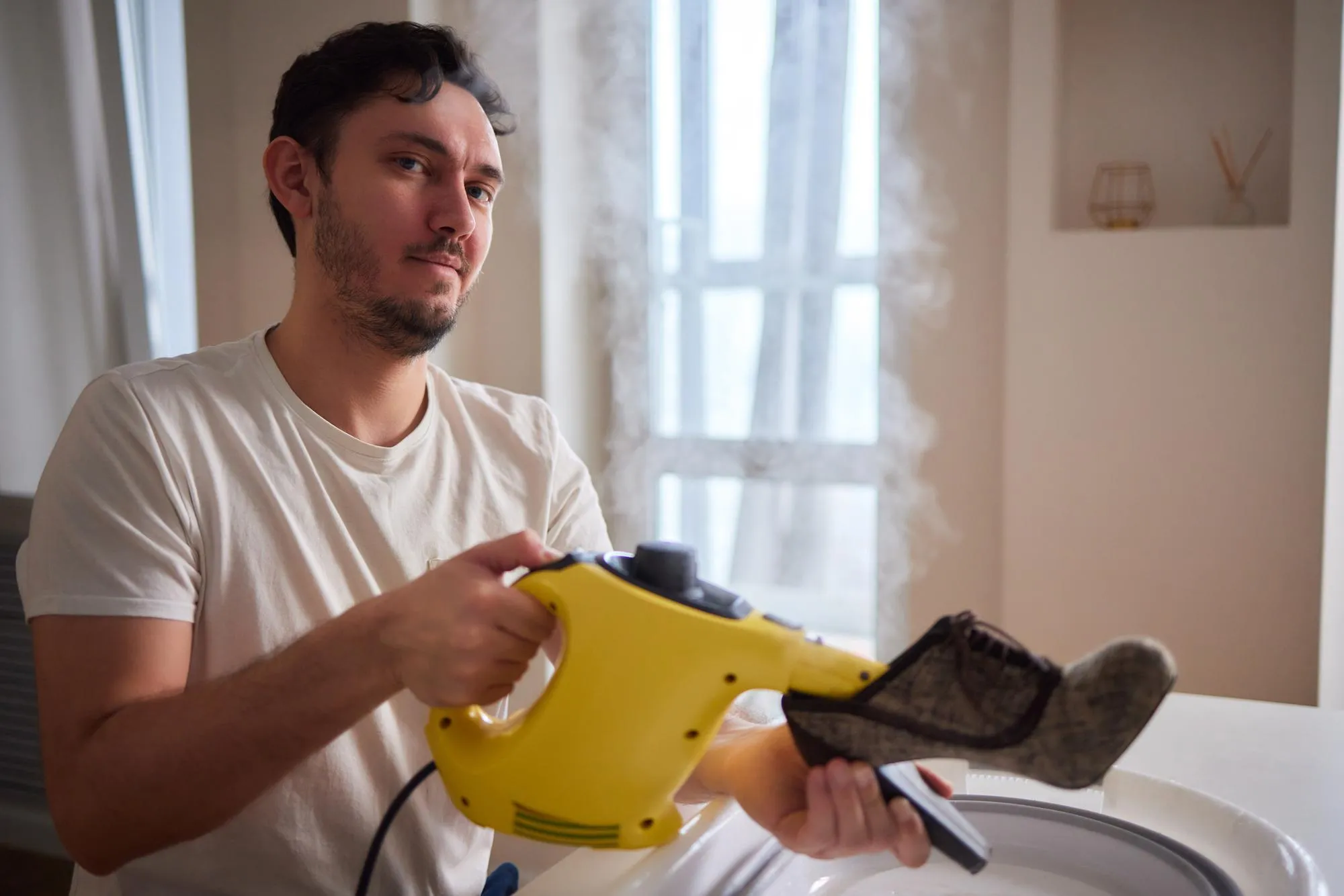 Washing the dirty cleaning the shoes with a steam cleaner