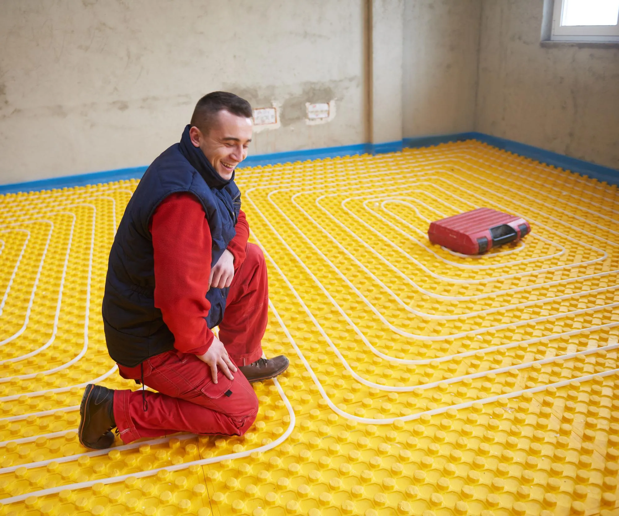 workers installing underfloor heating system