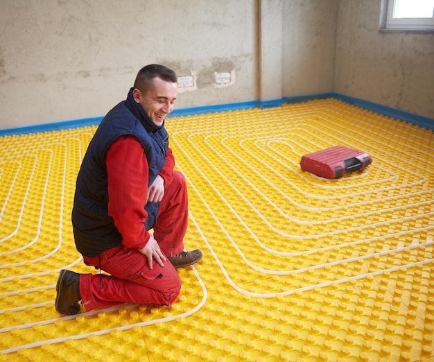 workers installing underfloor heating system