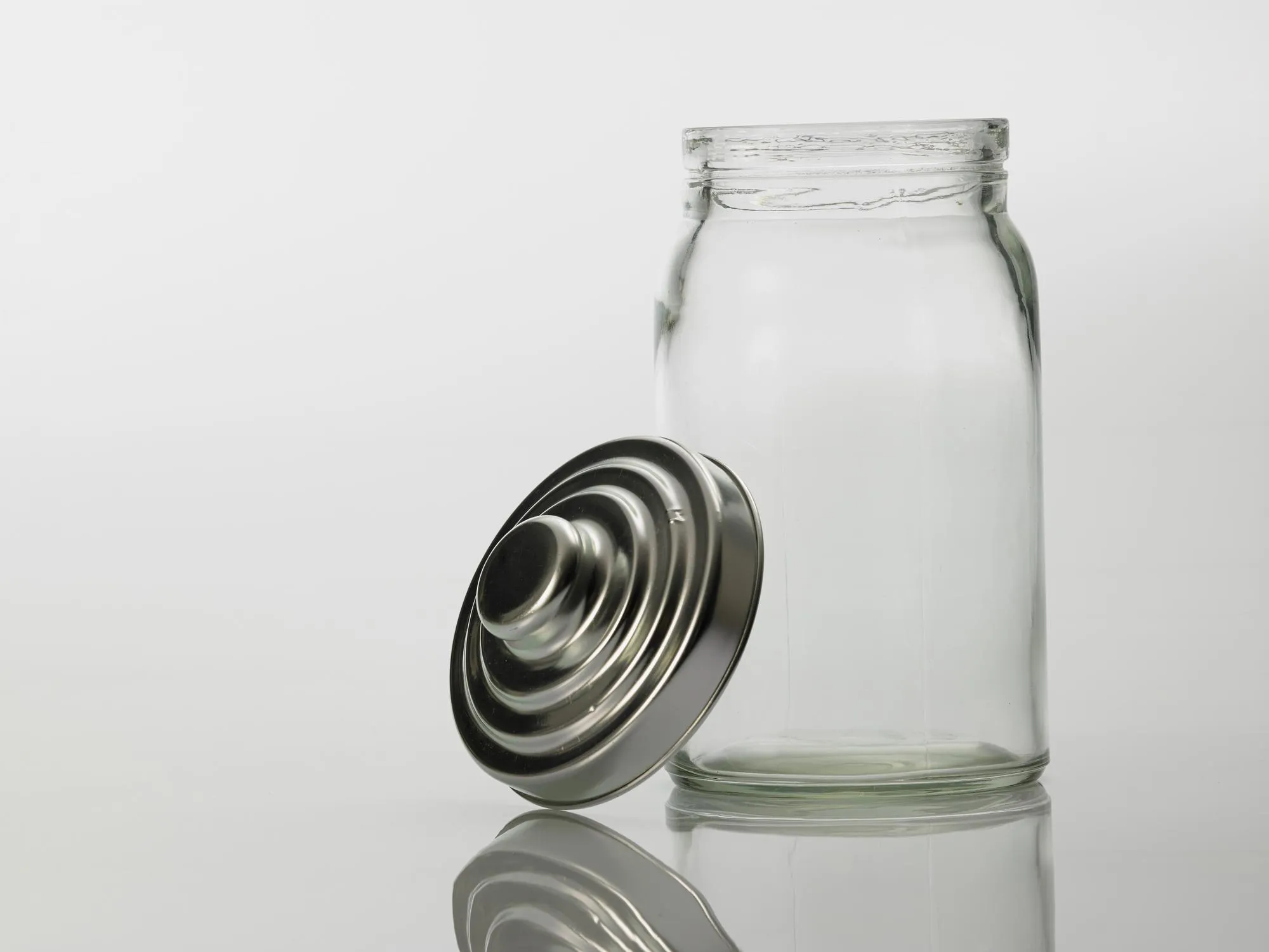 Close-up of empty glass bottle against white background