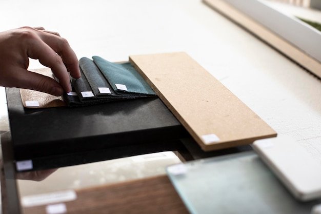 Close-up of person working on table with material  samples