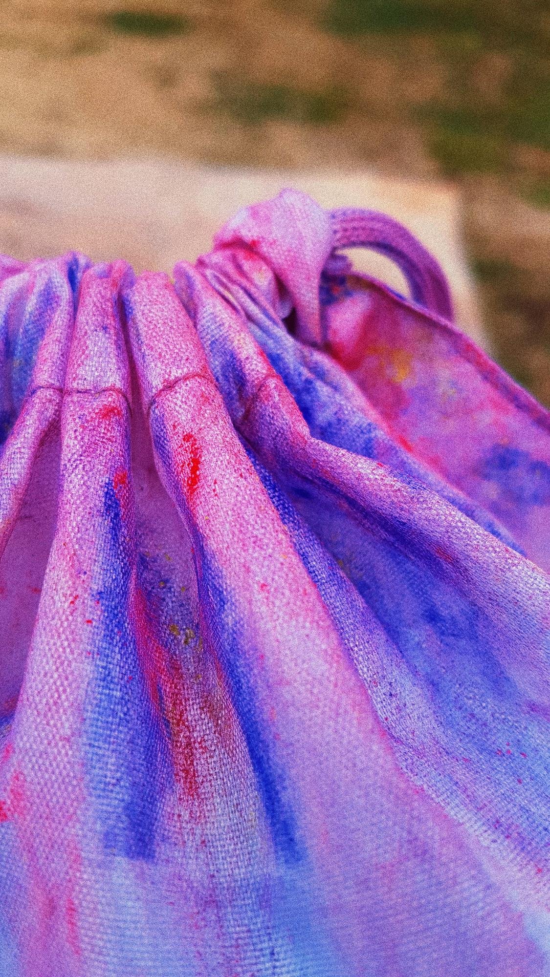 Close-up of textile bag covered with colorful powder paint