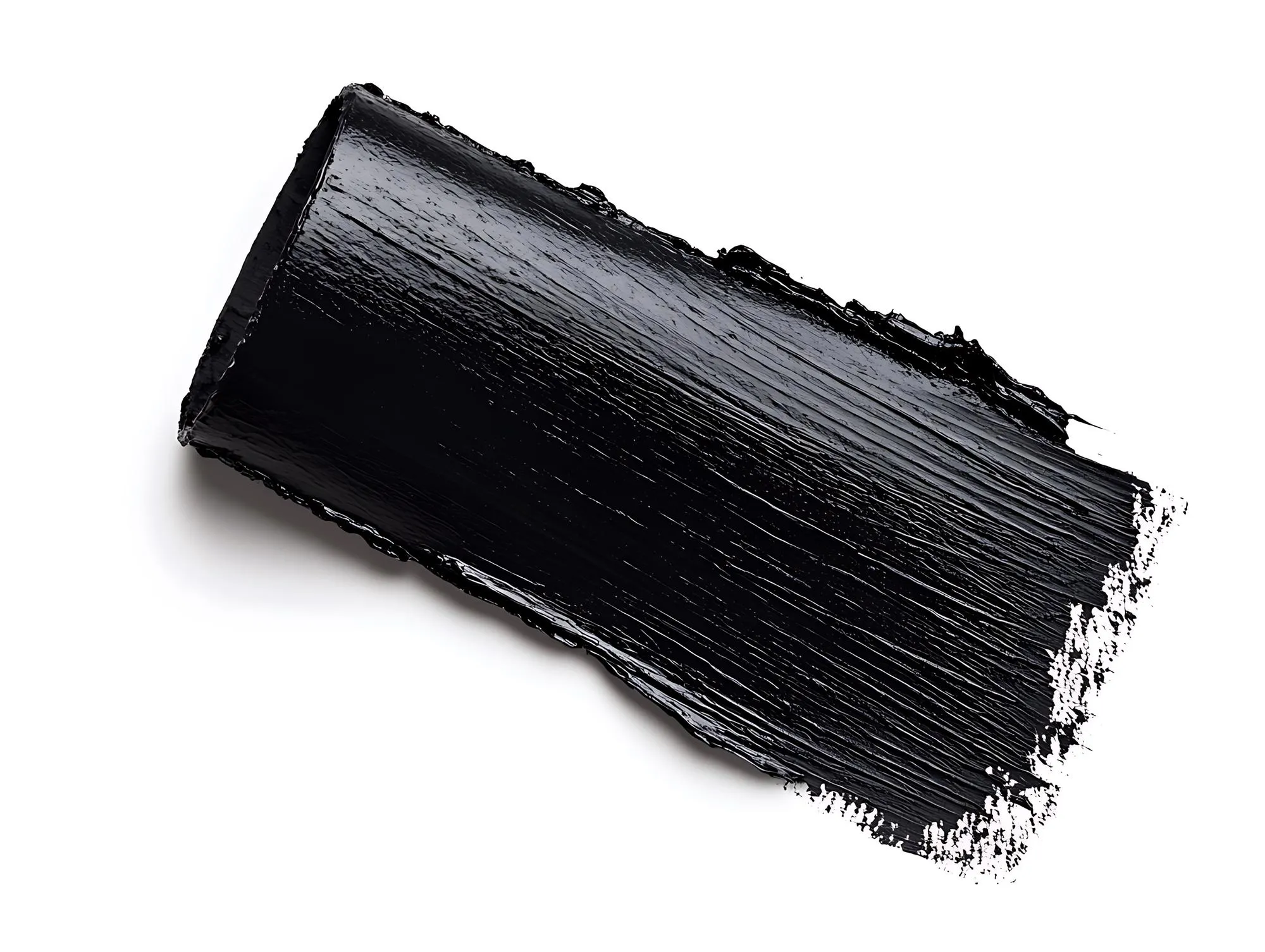 Closeup of a black paint stroke isolated on white