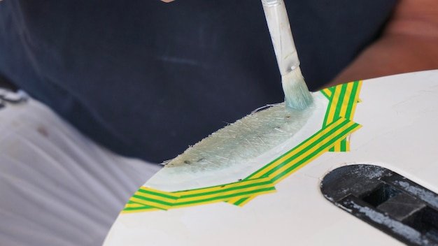 Covering surf board with white gel coat windsurfing board repair process