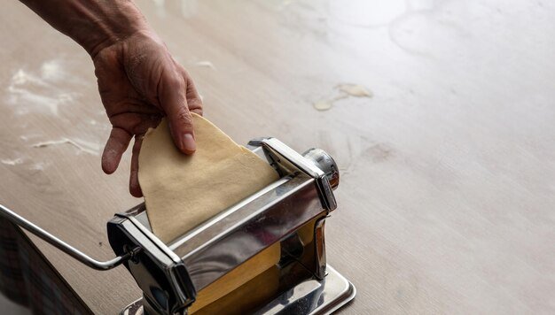 Fresh pasta maker machine Dough homemade preparation Hand make dough phylo close up view