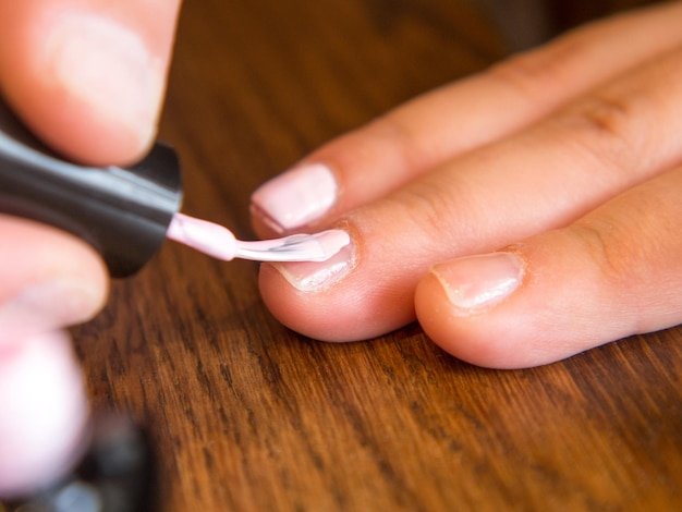 girl paints her nails with polish