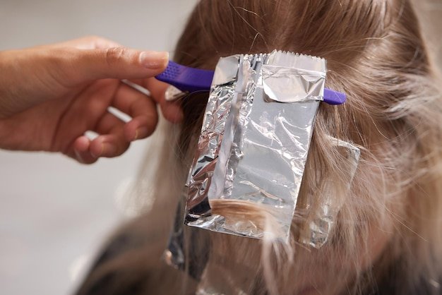 Hair stylist makes bouffant using comb on thin strands Shatush technique for hair lightening
