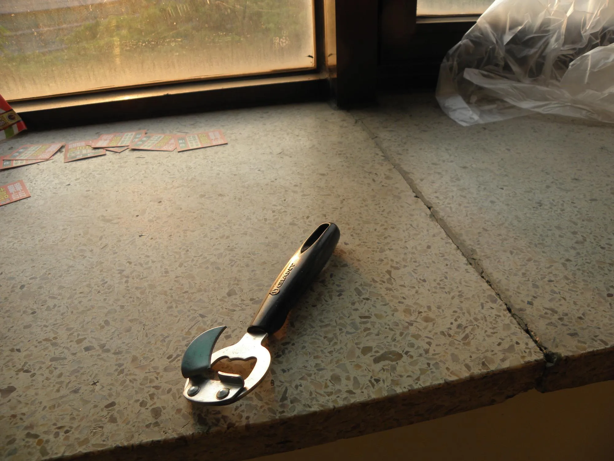 High angle view of can opener on window sill
