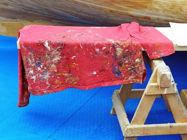 High angle view of dirty fabric on bench at workshop