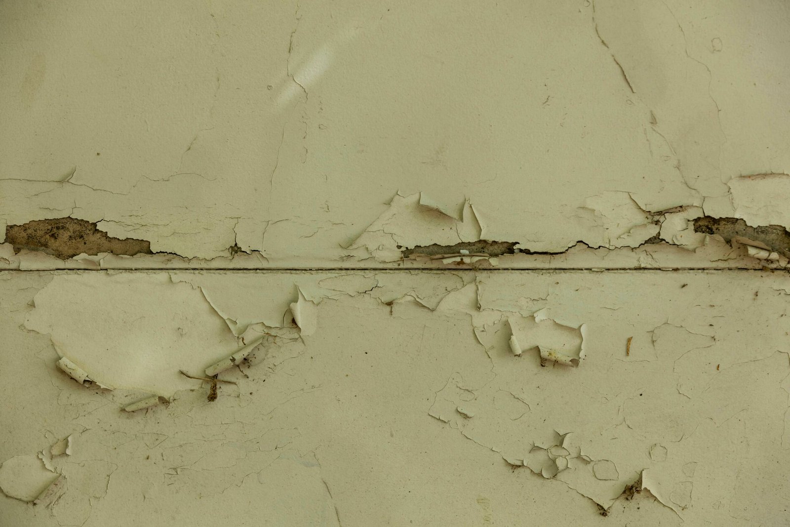 a close up of a wall with peeling paint