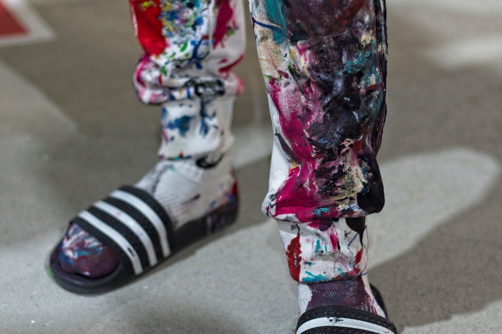 person wearing black and white striped rain boots