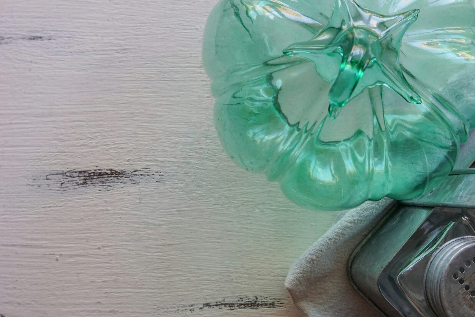 a green bottle sitting on top of a stove top oven