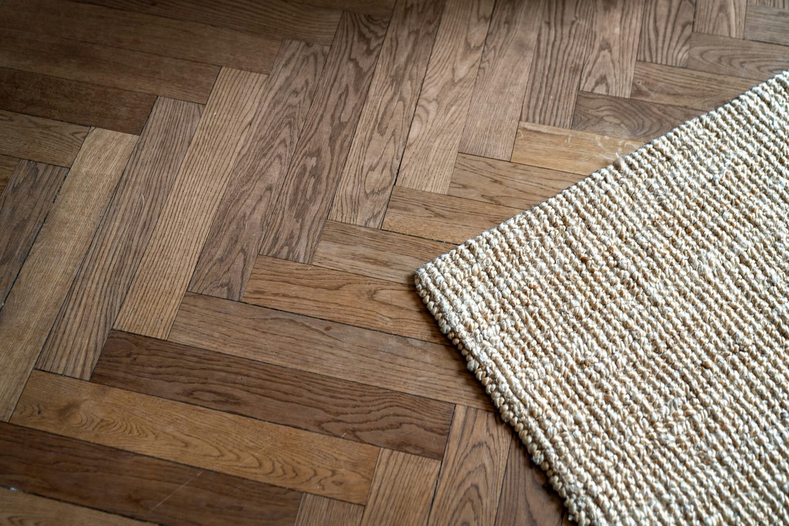 A close up of a rug on a wooden floor