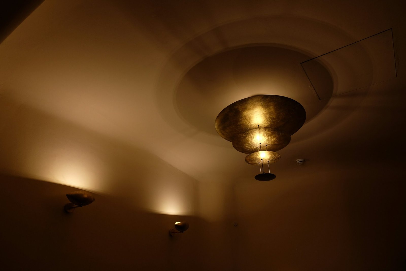 a dimly lit room with three lights on the ceiling