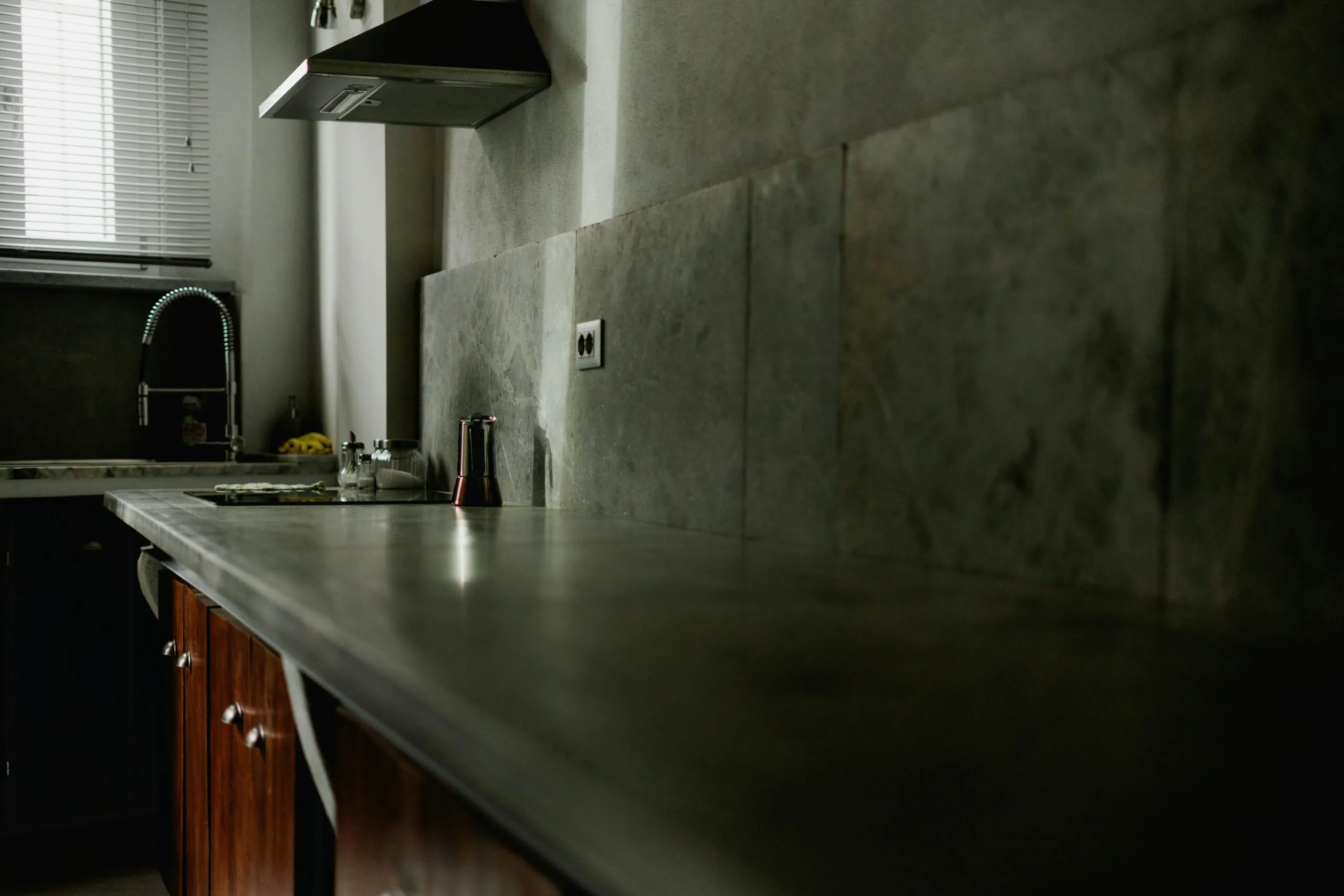 A kitchen with a stove top oven next to a sink