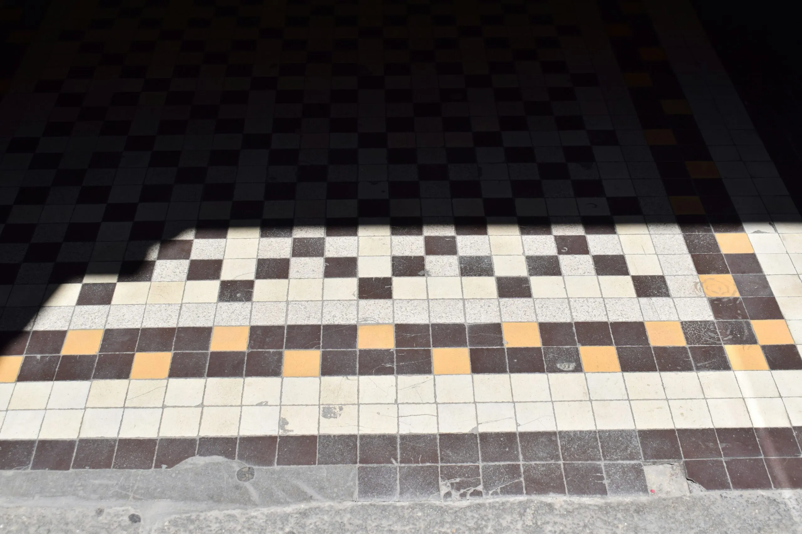 Checkerboard tile floor with shadows.