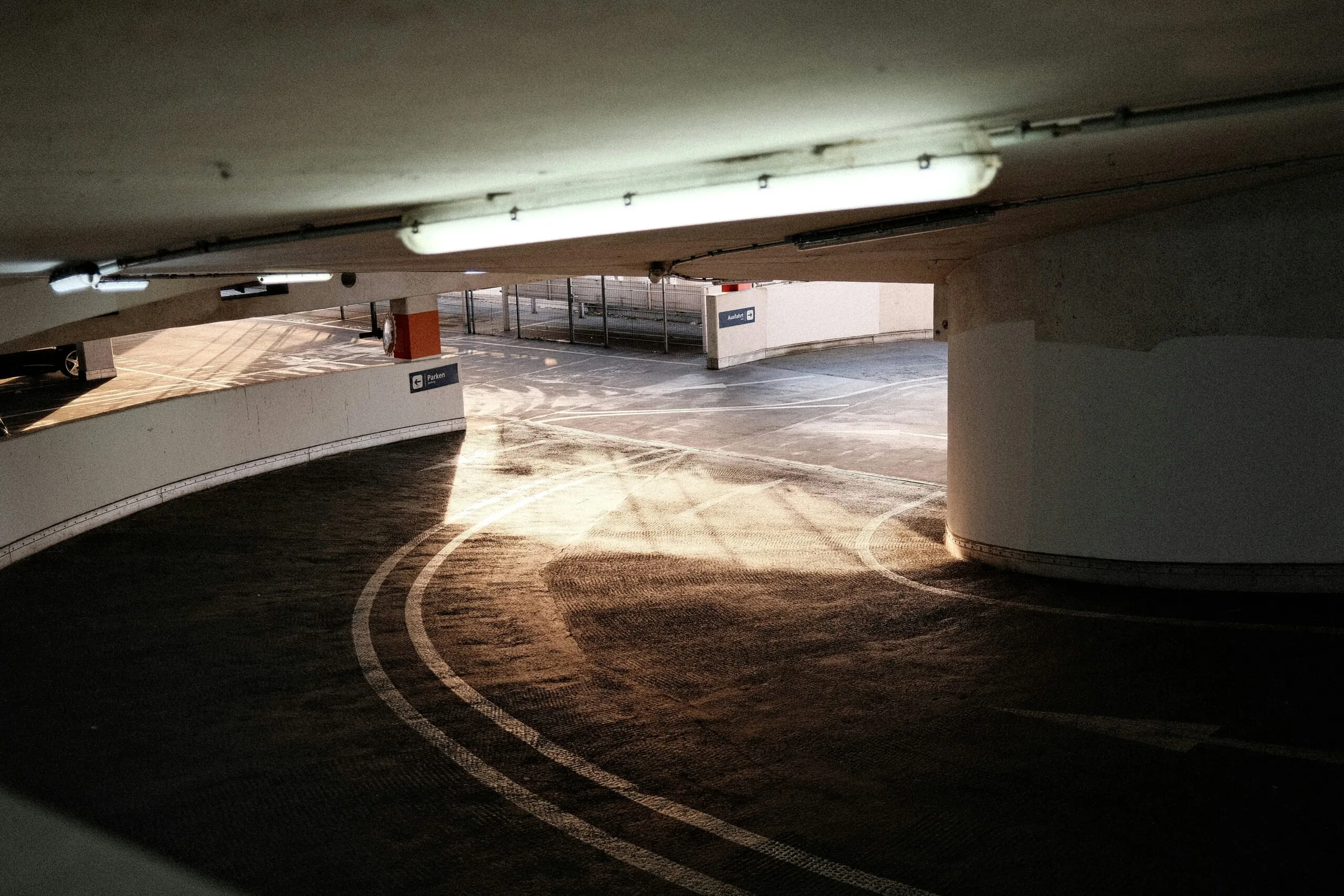 an empty parking garage with a parking meter