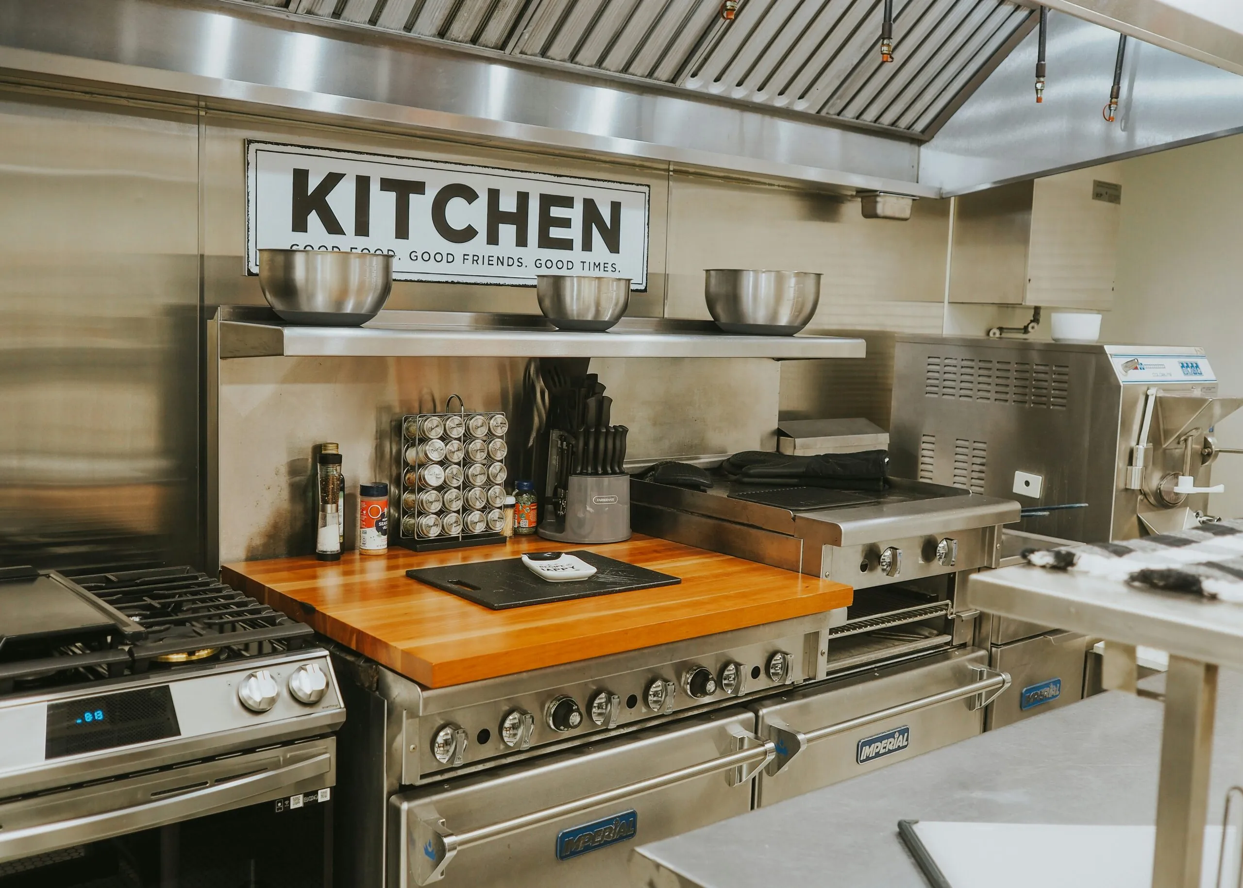 a kitchen with stainless steel appliances and a wooden counter