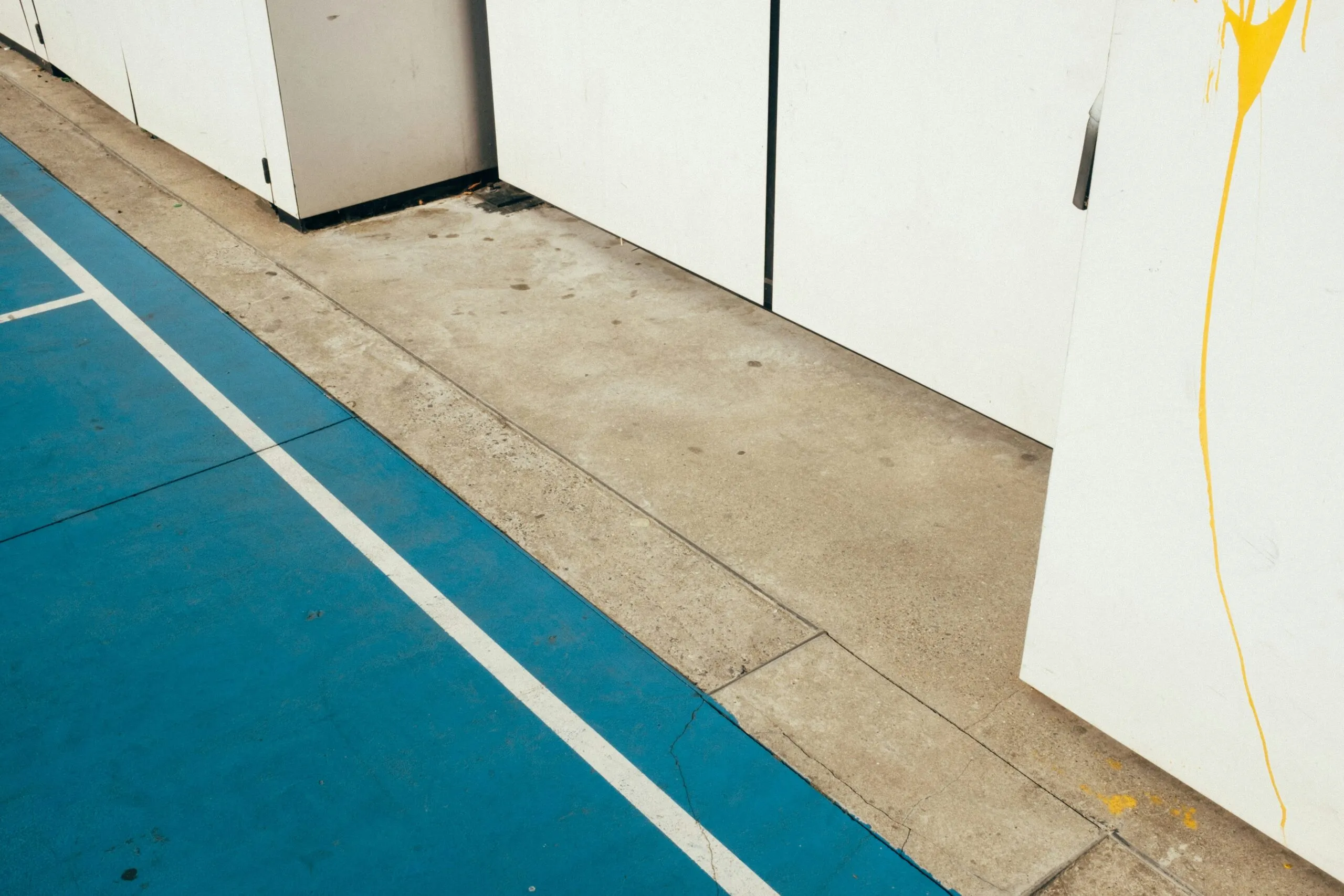 a white refrigerator sitting next to a white wall
