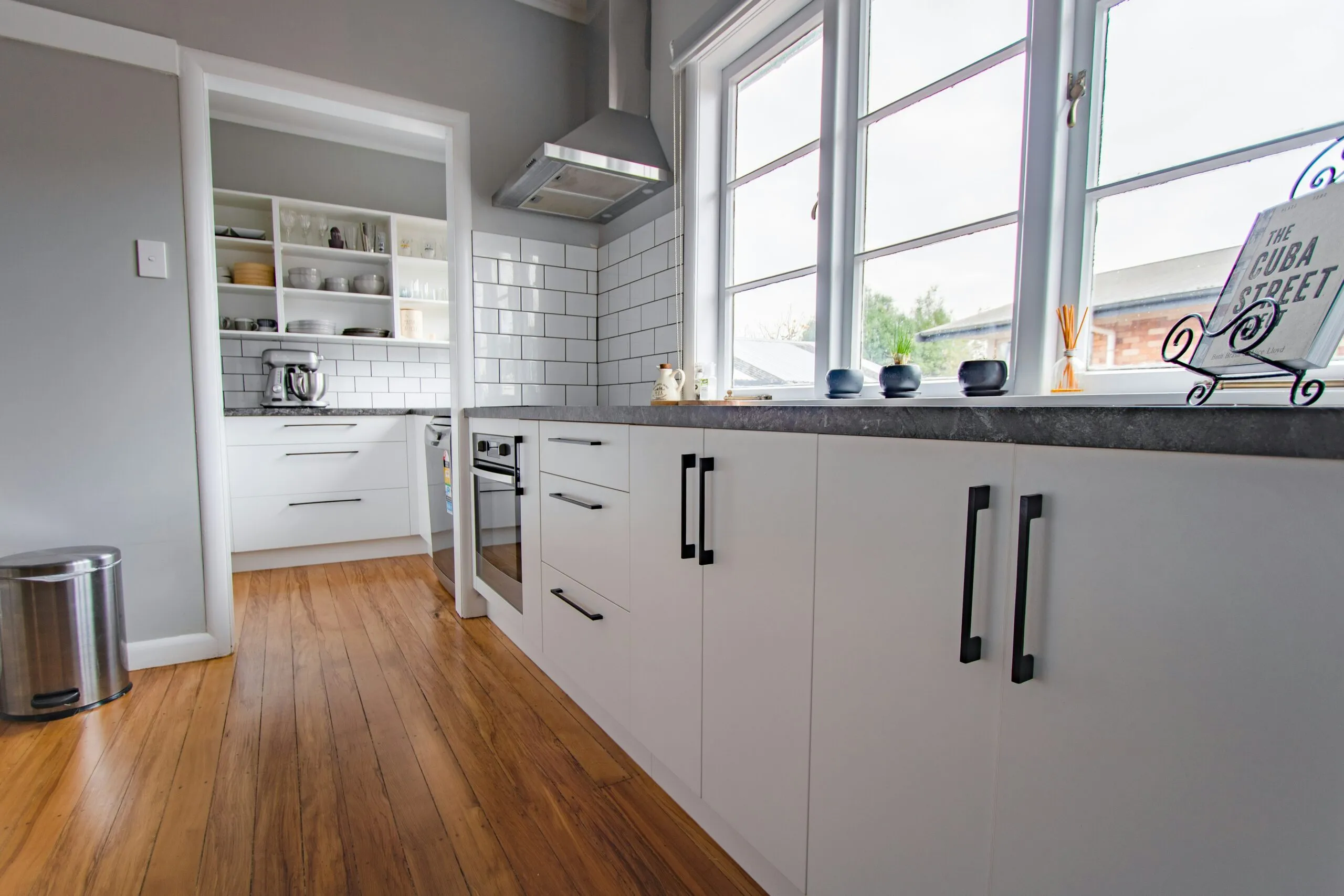 white wooden kitchen cabinet near window