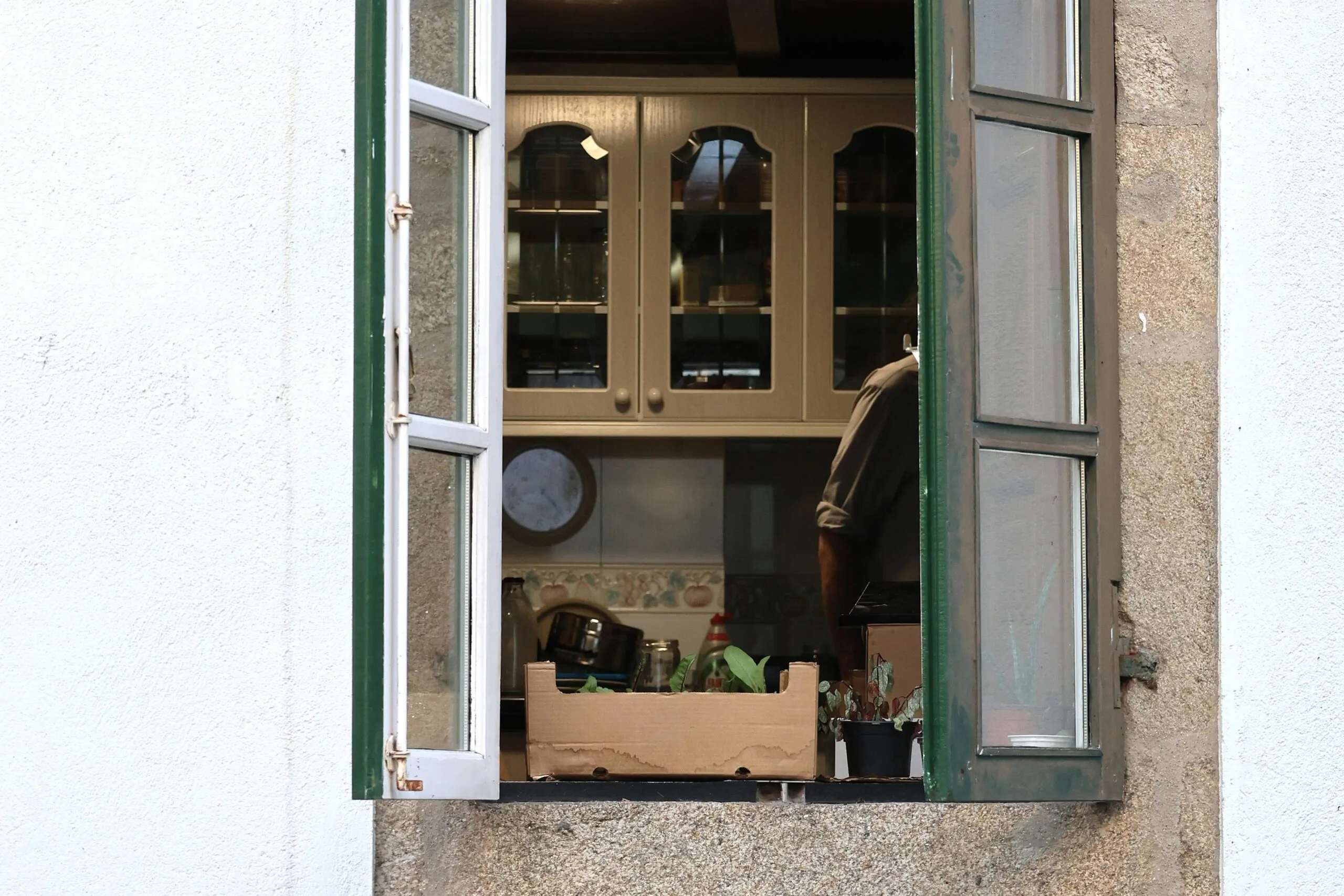 View into a kitchen through an open window.