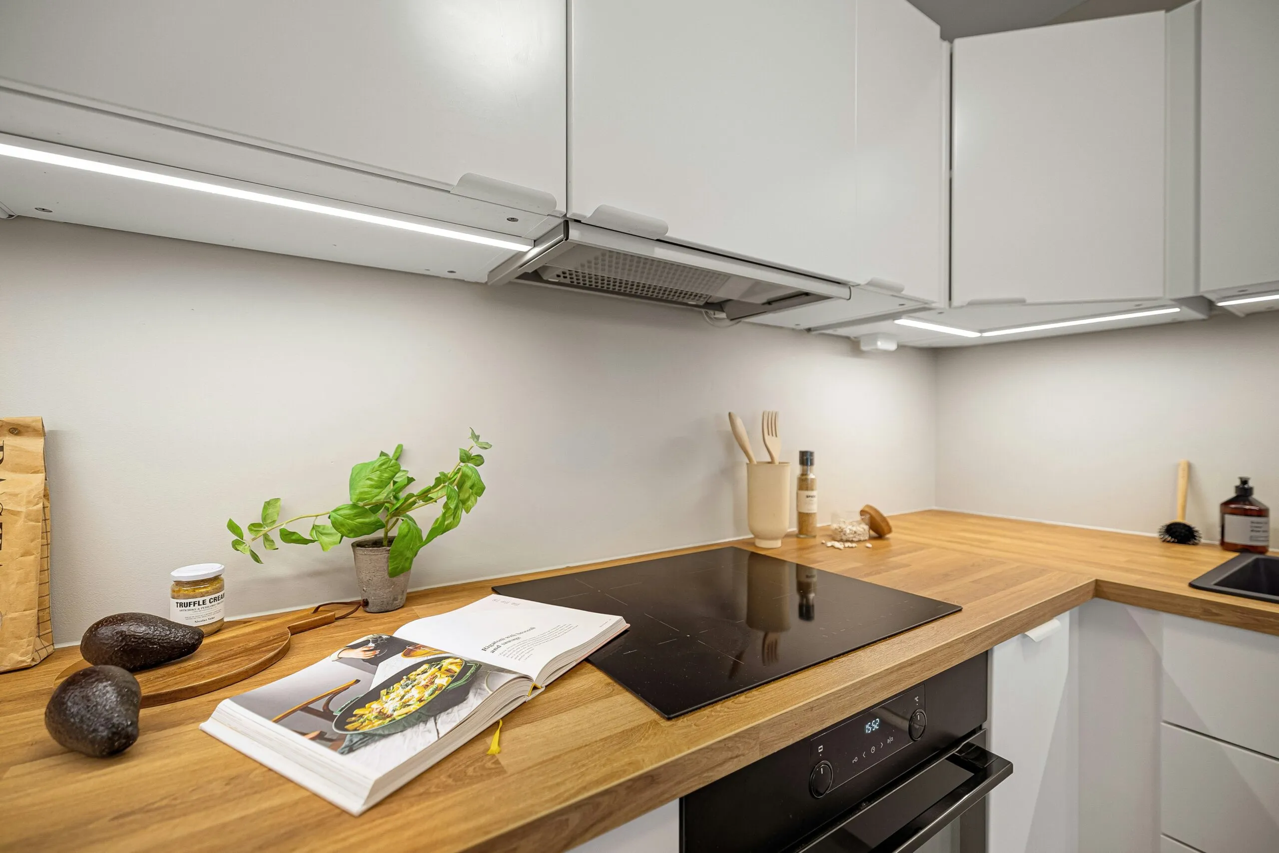 A kitchen with a stove top oven next to a counter