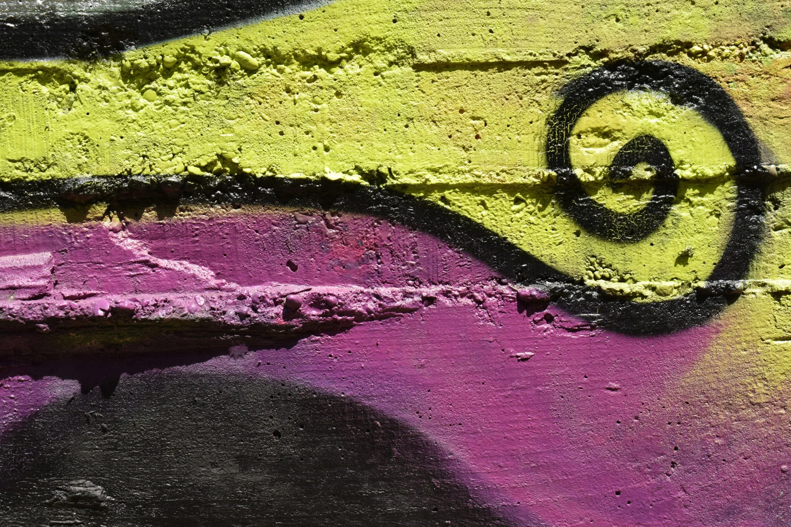 a close up of a wall with graffiti on it