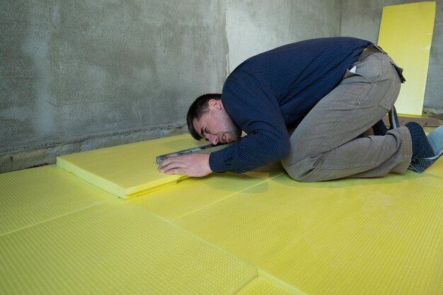 Installation of expanded polystyrene in the room for floor insulation repair work alone yellow expanded polystyrene
