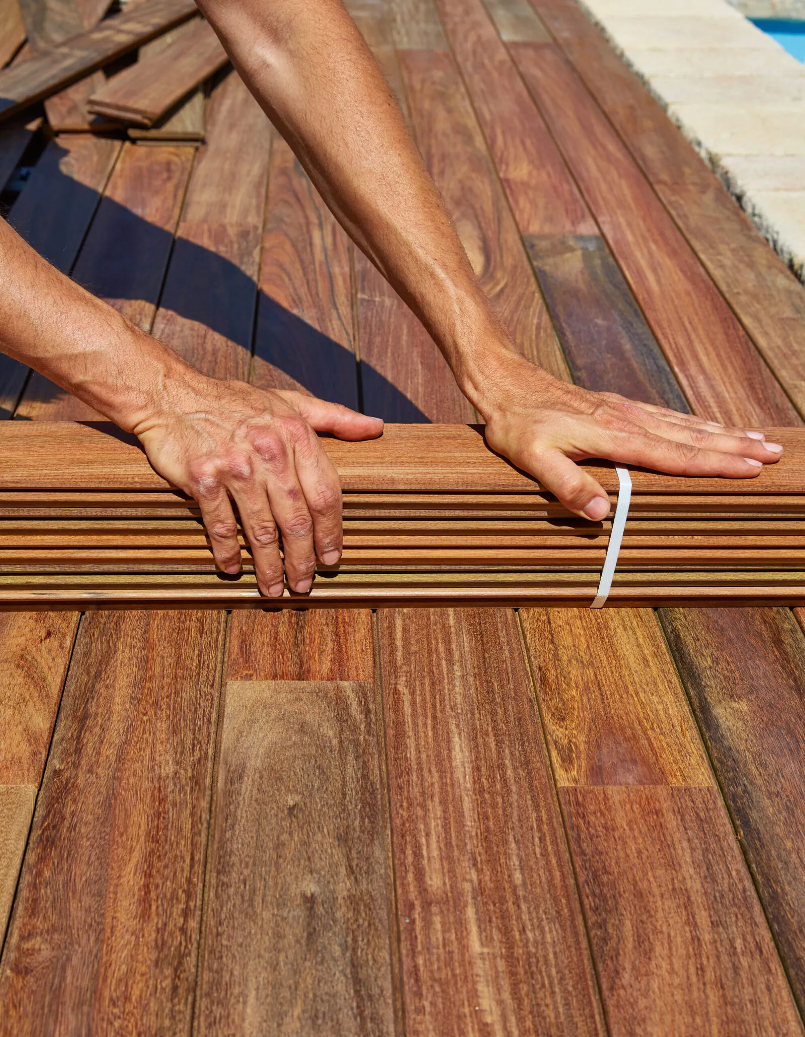 Ipe deck installation carpenter hands holding wood