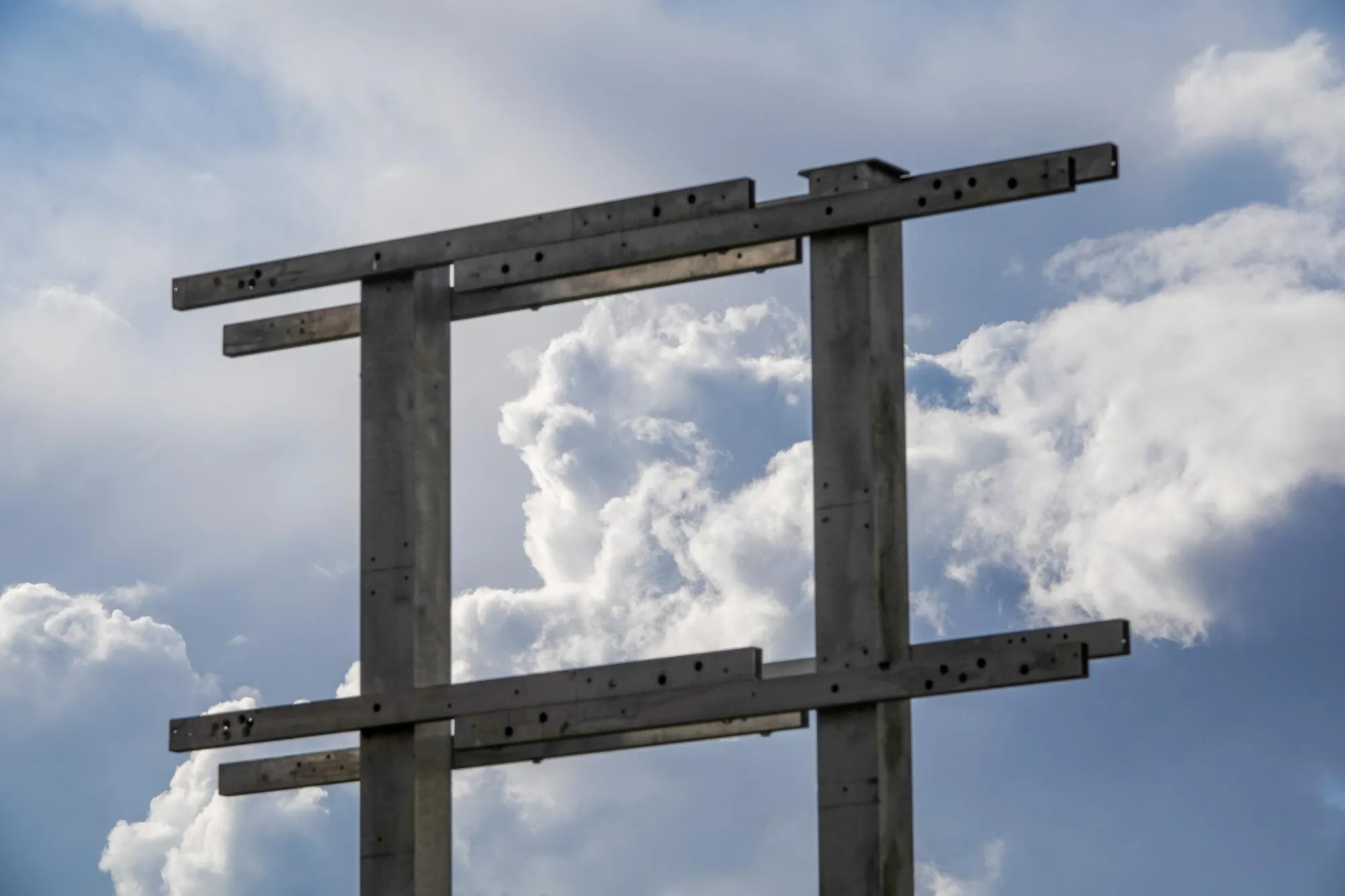Low angle view of cross against sky