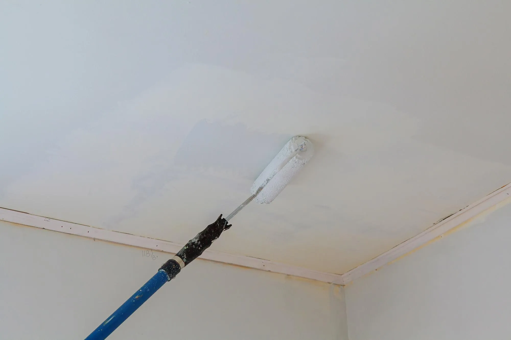 Low angle view of paint roller on ceiling