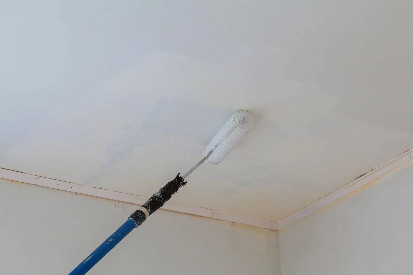 Low angle view of paint roller on ceiling