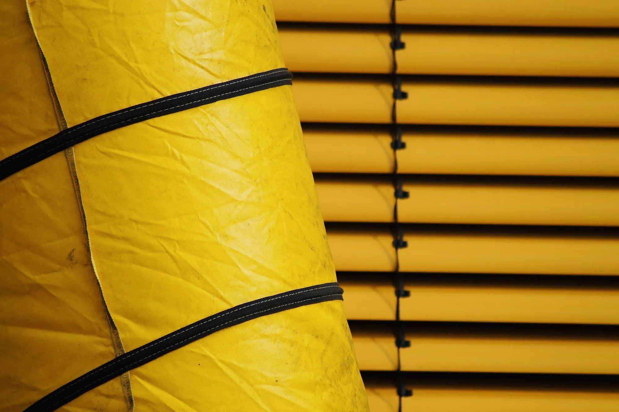 Low angle view of yellow pipe on wall