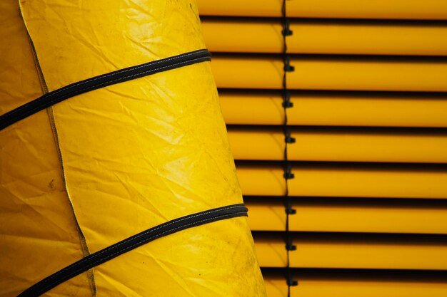 Low angle view of yellow pipe on wall