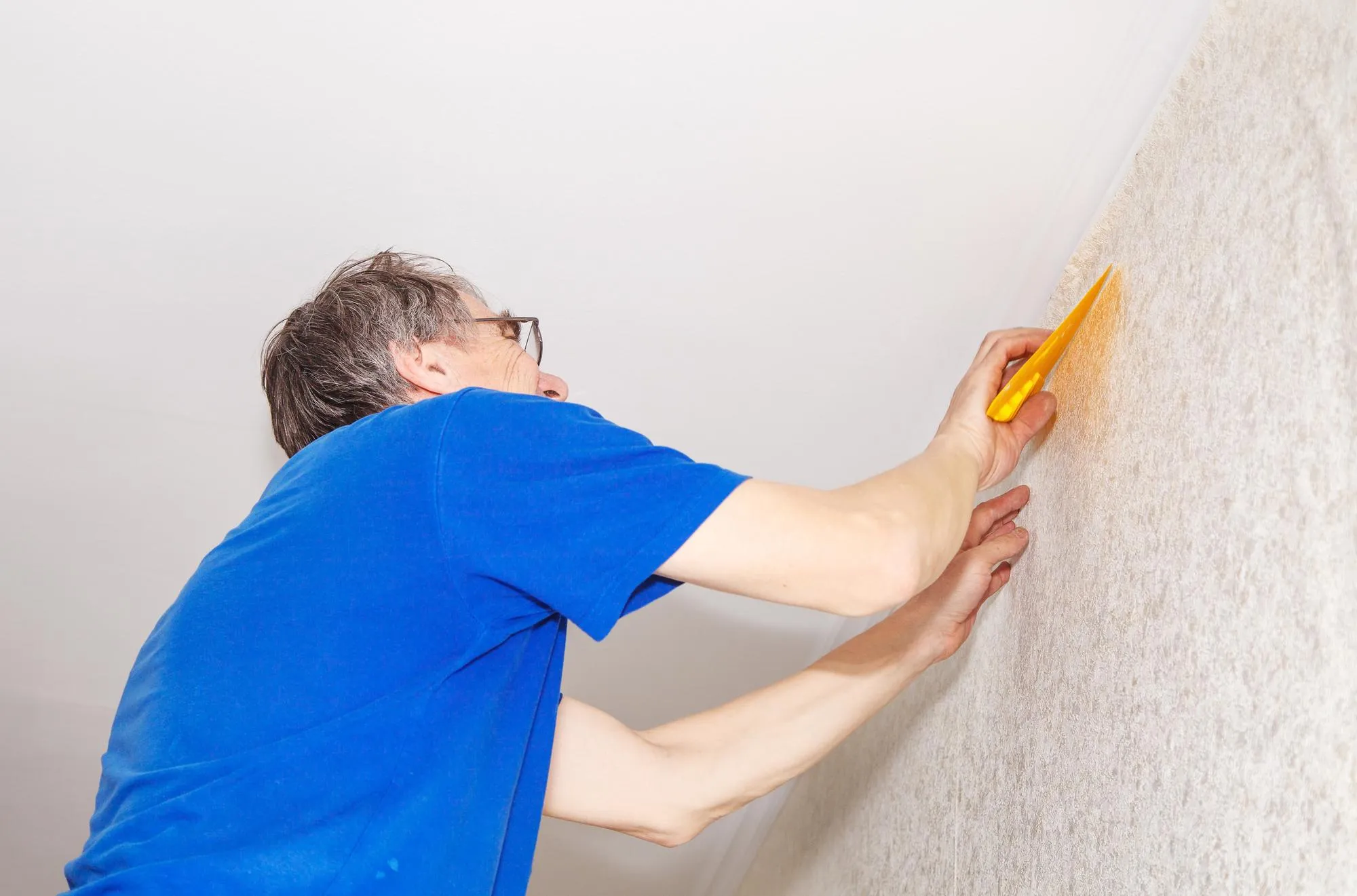 Man renovating wall at home