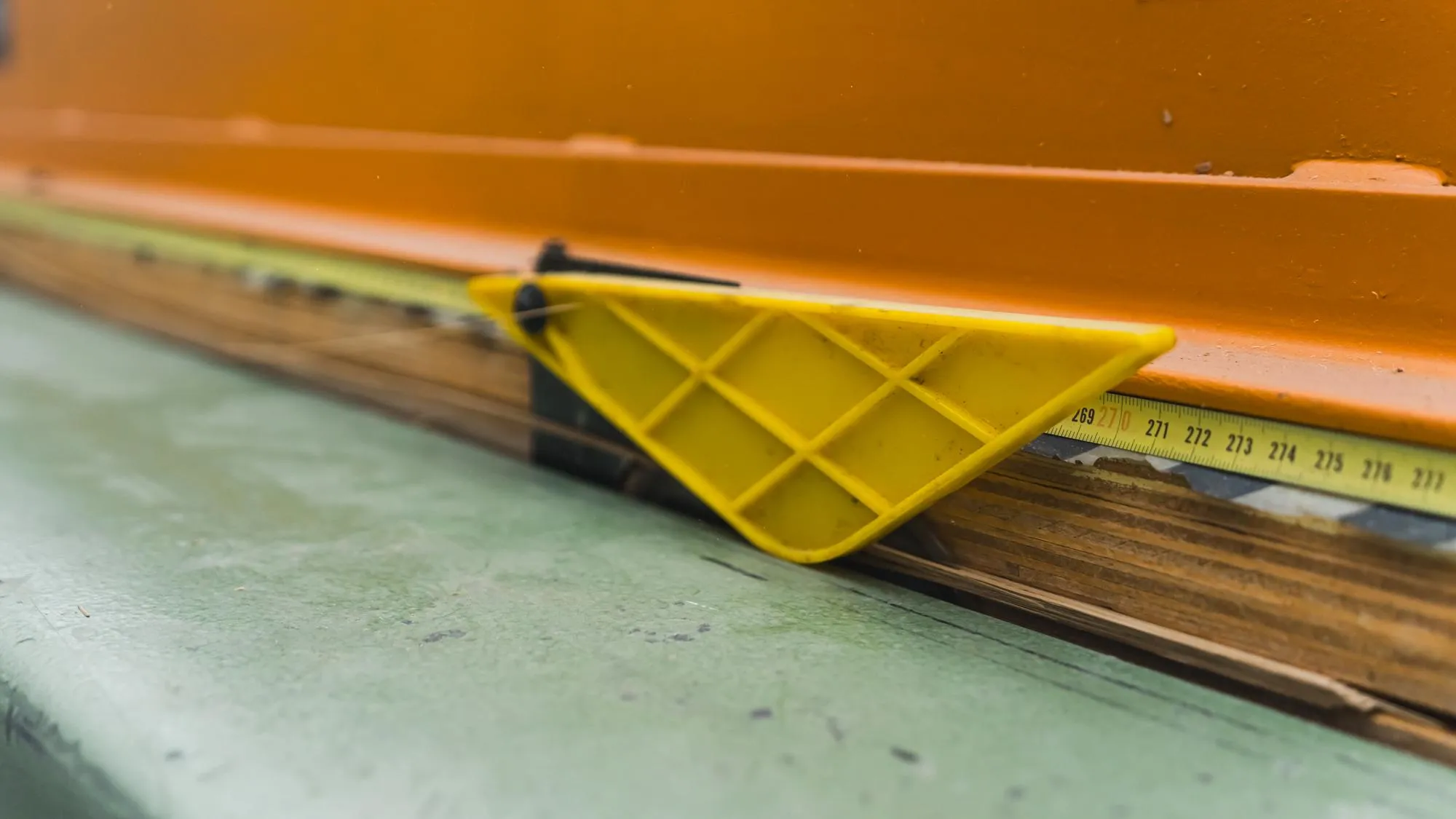 Measuring tape on the wood thing to measure the length workshop